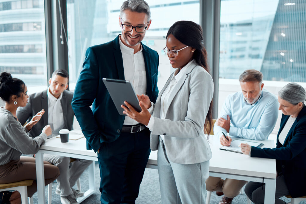 Business people, tablet and conversation with ceo for planning and collaboration in office. Technology, teamwork and black woman with mentor in discussion, communication and research on digital app